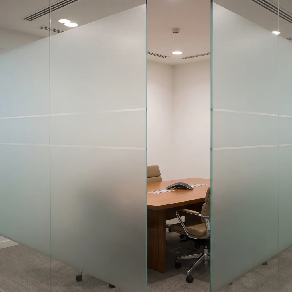 Office glass partition Downtown Dubai featuring translucent frosted glass by MAJLIS HIKMA ALUMINIUM & GLASS LLC, providing visual privacy for a meeting room.