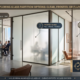 Comparison infographic illustrating three types of custom glass partitions: Clear (Maximum Light), Frosted (Optimal Privacy), and Fluted (Textural Elegance) in a modern office with Dubai views. Includes icons and company footer: MAJLIS HIKMA ALUMINIUM & GLASS LLC, DUBAI, UAE.